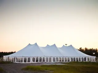 White party tent set up for an outdoor event