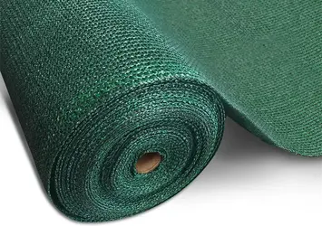 Green shade net material stretched over an agricultural area
