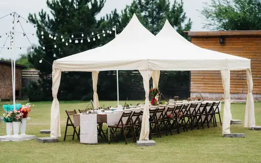 Elegantly decorated tent interior at a wedding venue